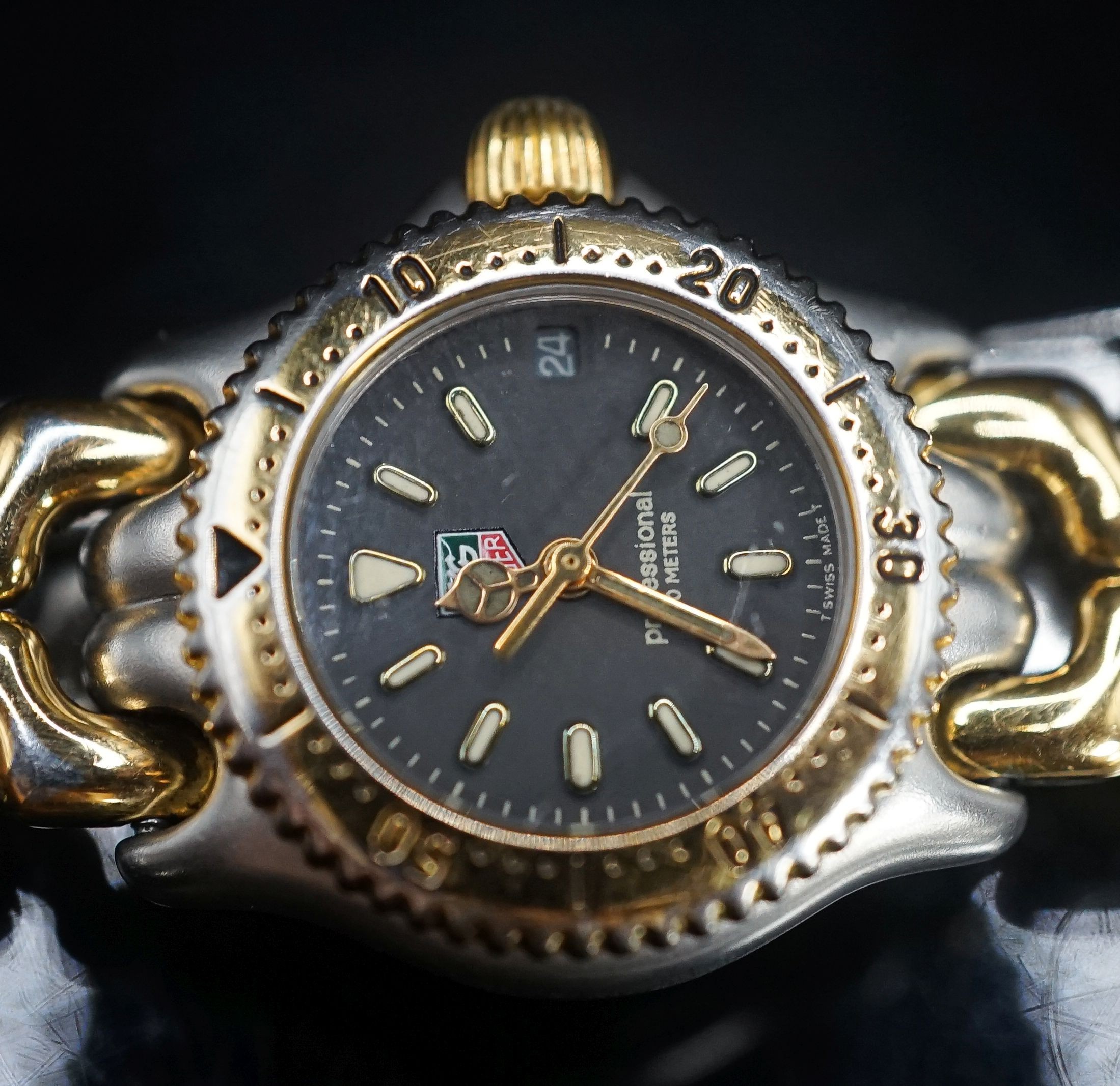 A lady's modern steel and gold plated Tag Heuer Professional quartz wrist watch, no box or papers.